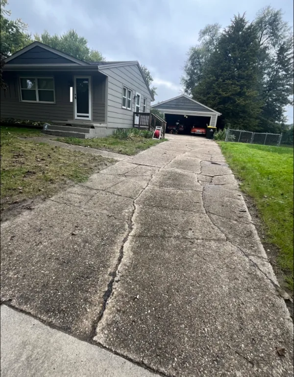 Before: cracked and heaving concrete driveway in front of a Des Moines house