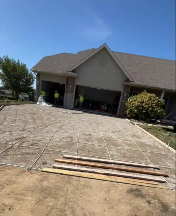 Forms and rebar grid set in front of a three-car garage before the pour, Medina Concrete
